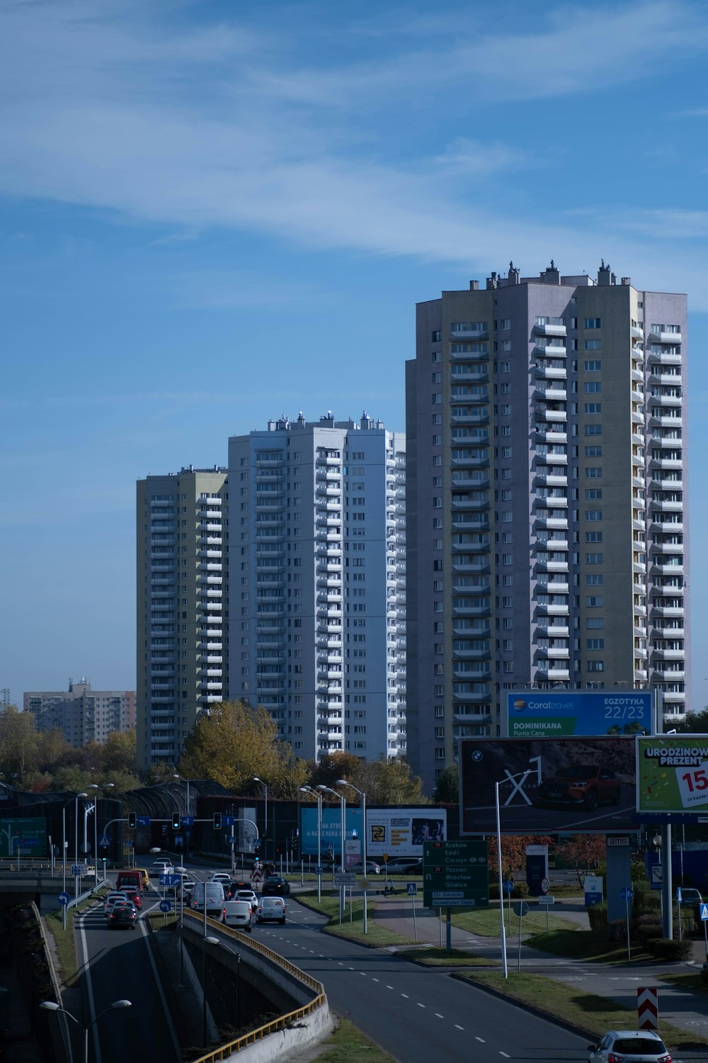 a city street with tall buildings in the background