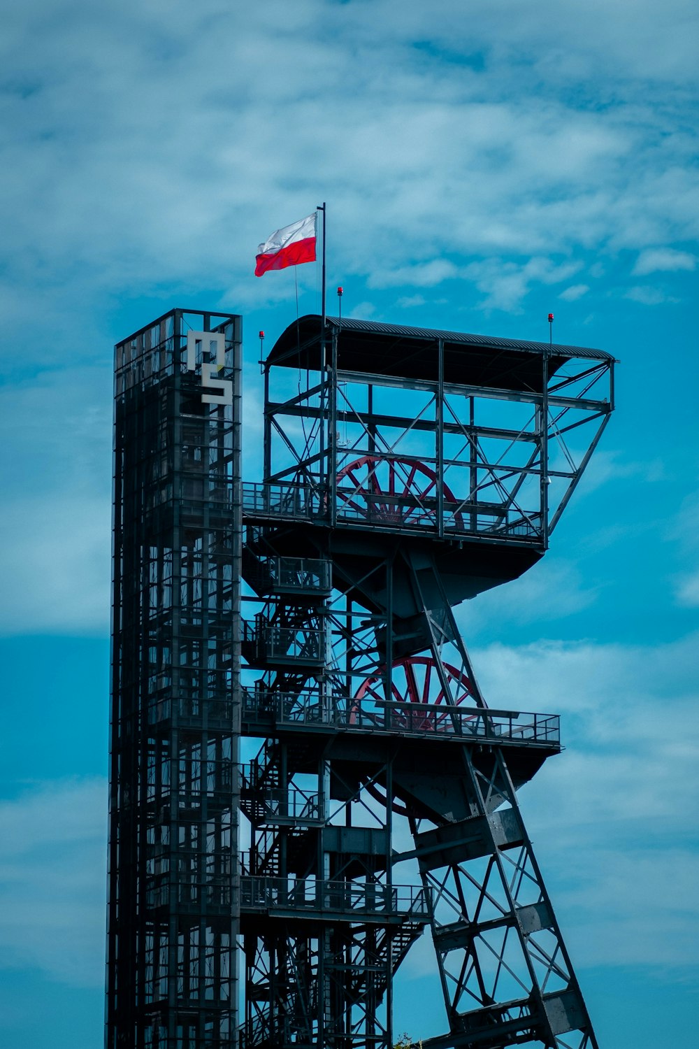 a tall building with a flag on top of it