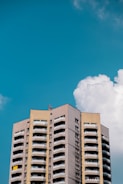 A completed multi-story building against a clear blue sky.