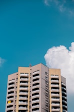 A completed multi-story building against a clear blue sky.
