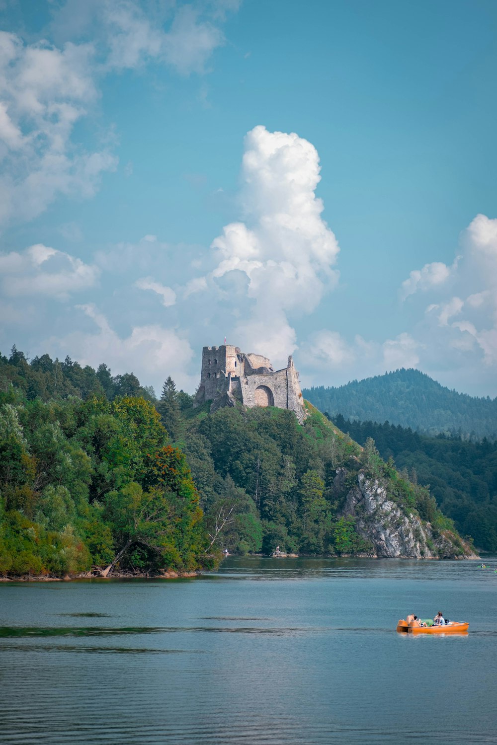 a boat in the water with a castle in the background