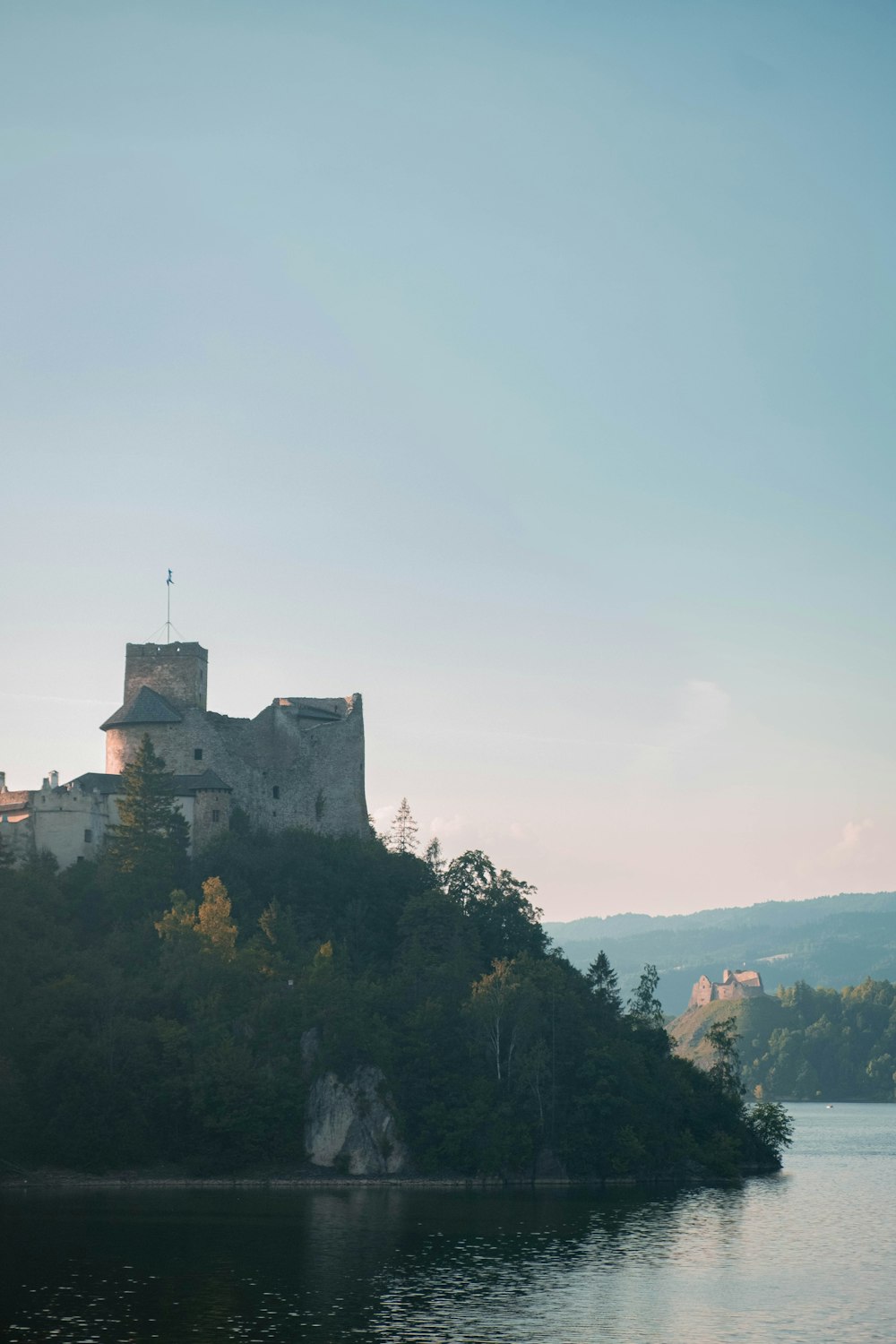 a castle on a small island in the middle of a lake