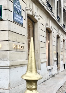Wide angle view of a high-end store front showcasing metal and glass facade in daytime.