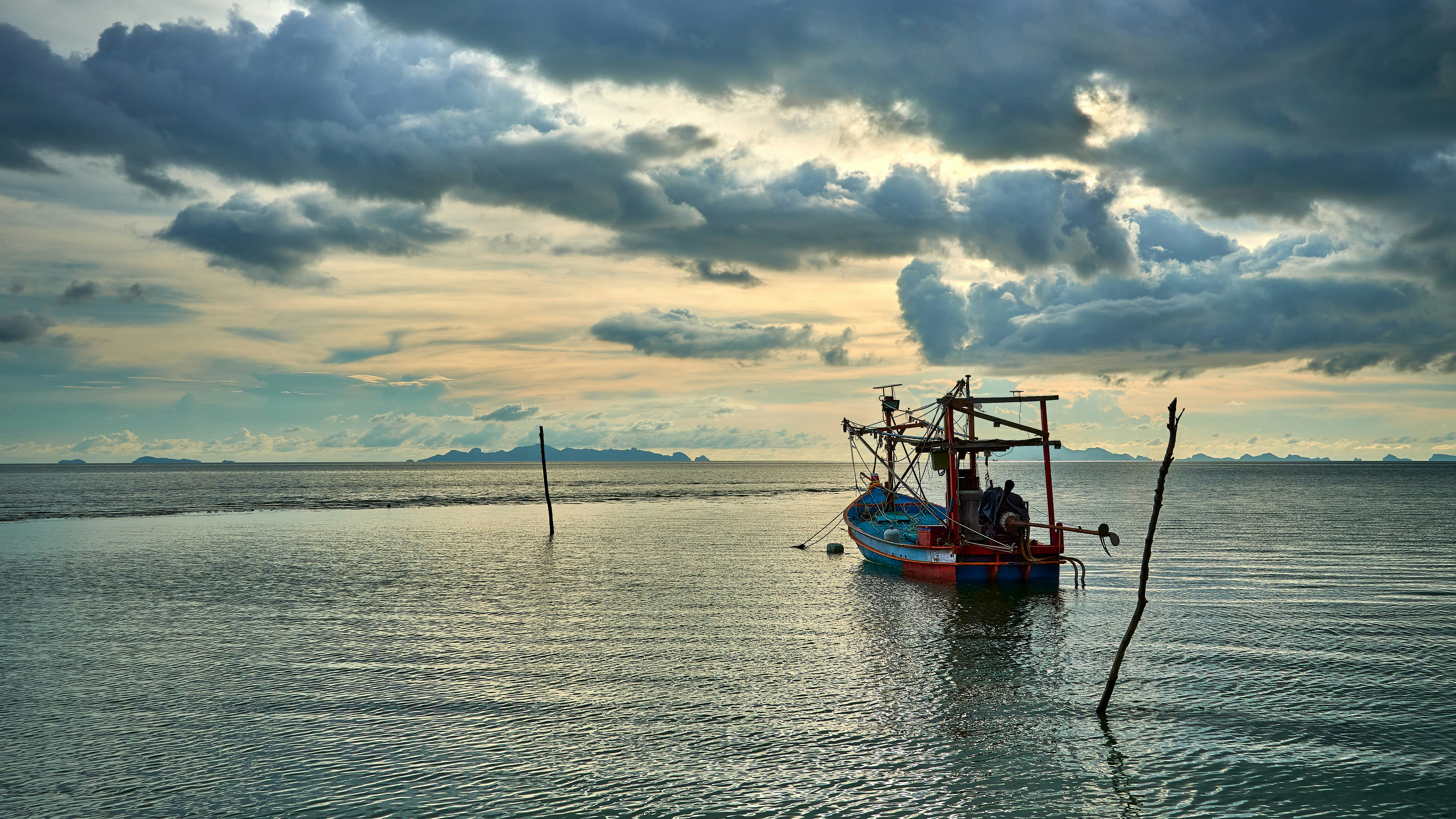 a fishing boat in the middle of a body of water