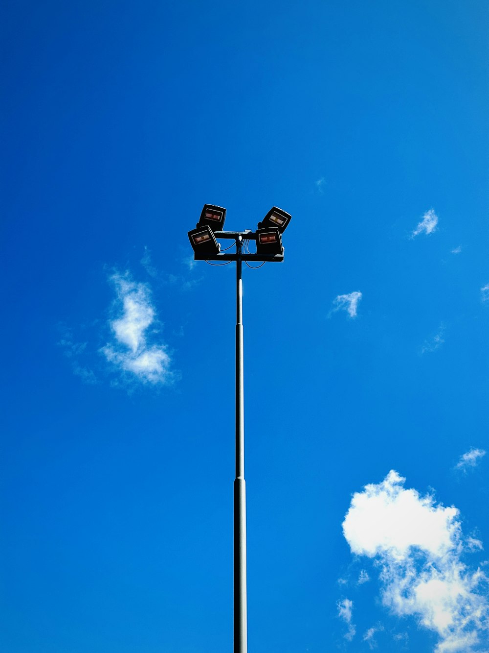 a street light with a blue sky in the background