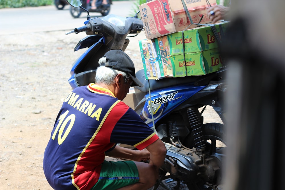 a man sitting on a motorcycle with boxes on the back of it