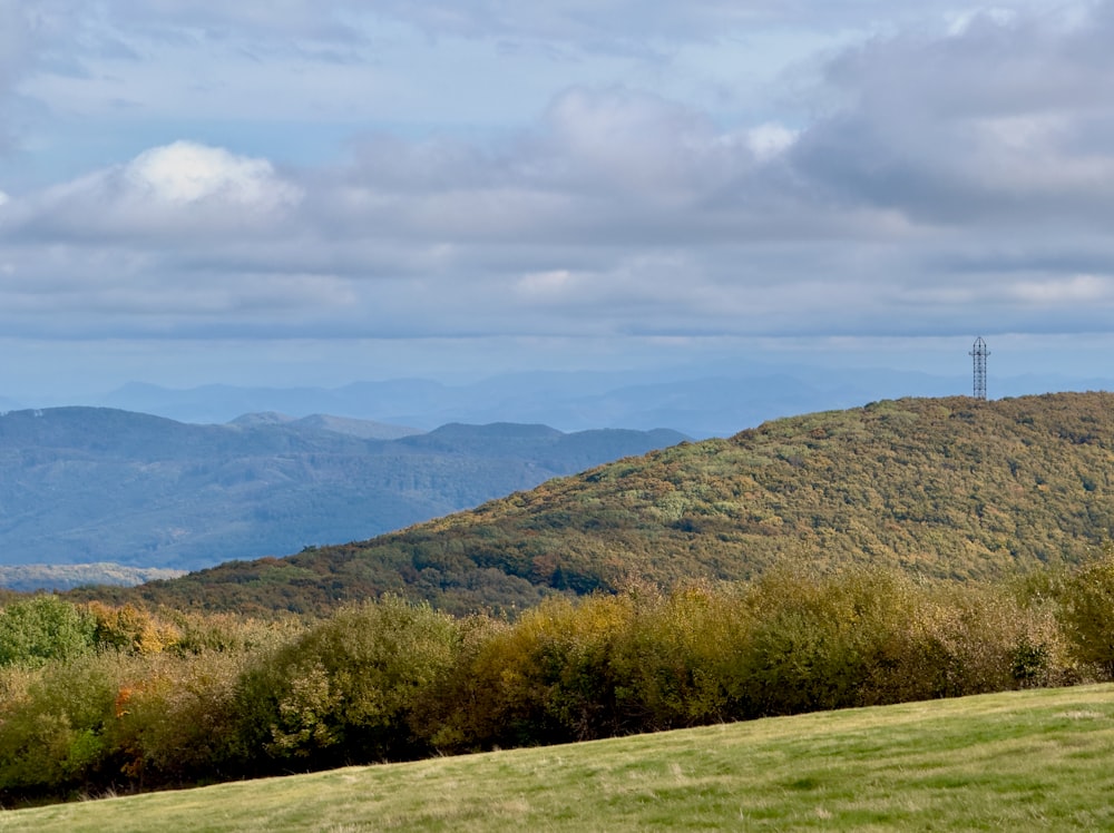 a view of a mountain range with a cell phone tower in the distance