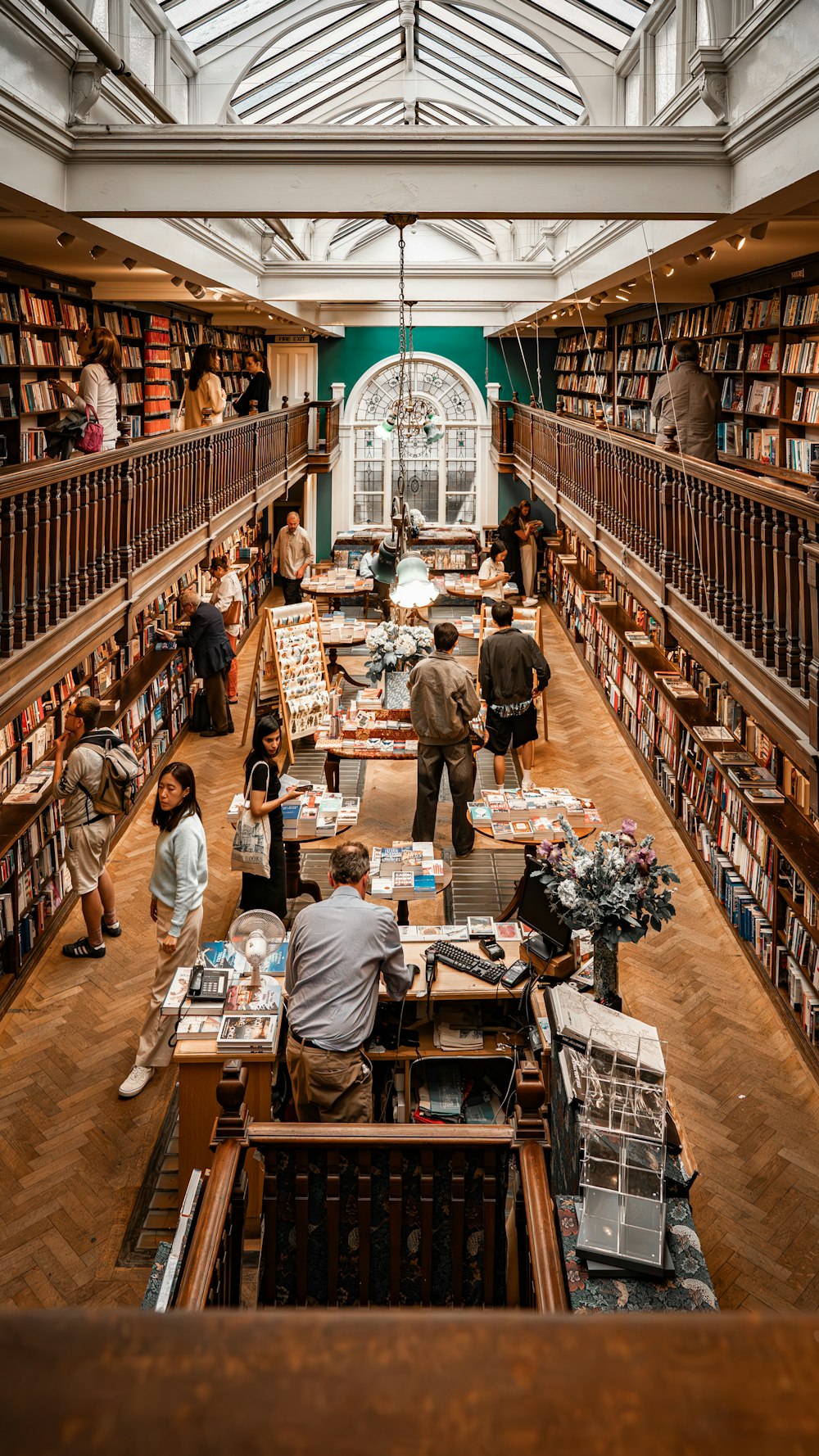 a library filled with lots of books and people