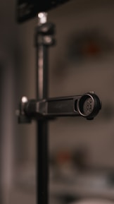 Blueprint-style technical drawing of the CalibraLock mount, highlighting its universal fit and secure clamp.