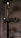 A close-up image of a metal stand with a clamp labeled 'GUARD LOCK.' The background is blurred, giving a shallow depth of field effect.