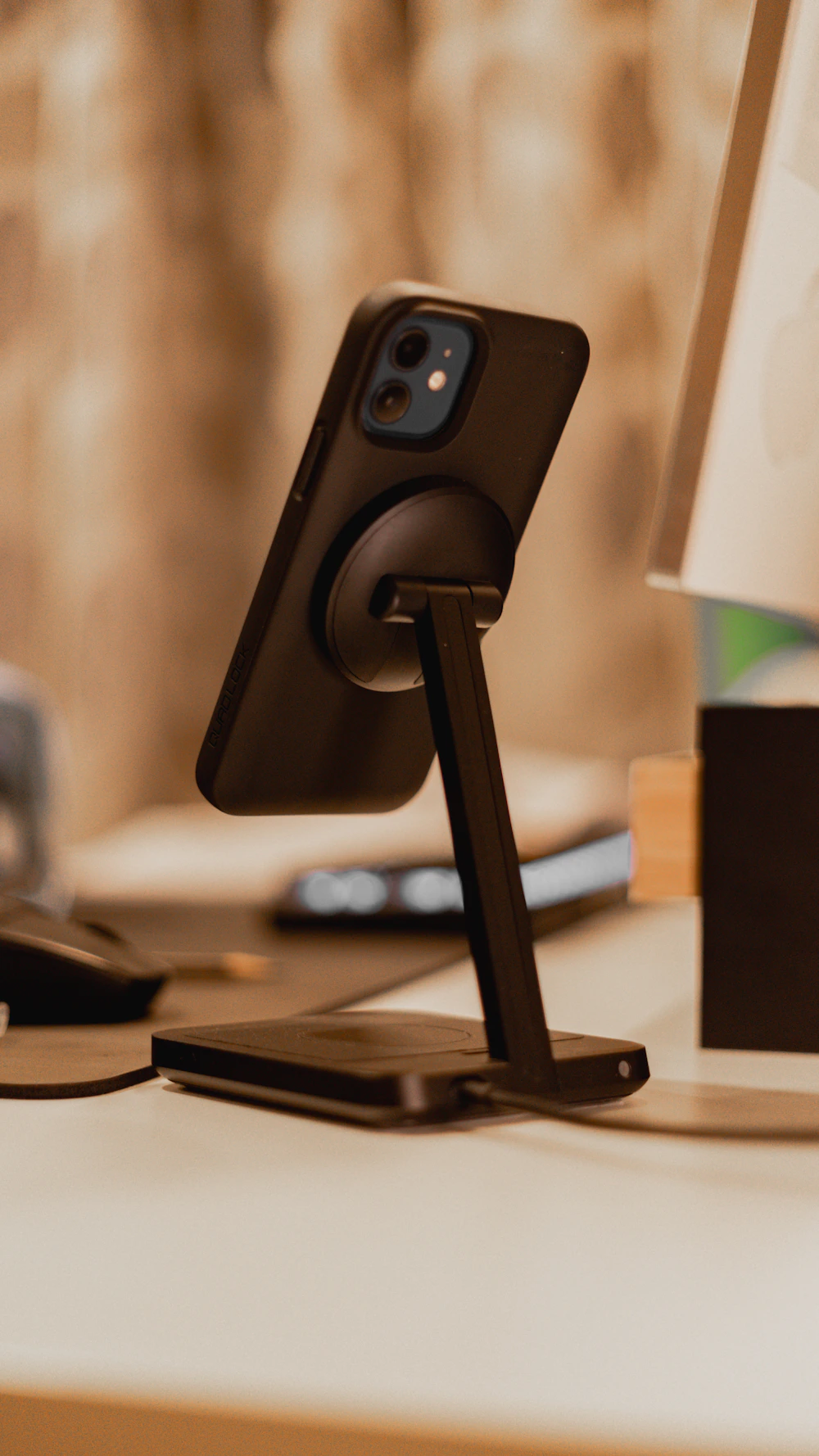 Smartphone resting on a desktop charging stand