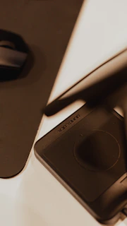 Close-up of a sleek Huion graphic tablet with a stylus resting on its surface, highlighting its smooth texture and buttons.
