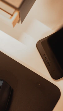 Personalized 3D printed gadget holder in black with orange highlights.