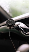 Car mount phone holder attached to a dashboard showing multi-angle adjustment.