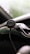 Close-up of a car dashboard with a phone holder and charger in use.