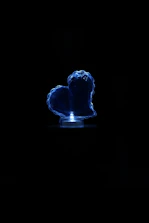 A protective amulet glowing softly amid a background of deep blue fabric.