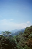 A panoramic view of a mountainous landscape with lush greenery under a clear sky.