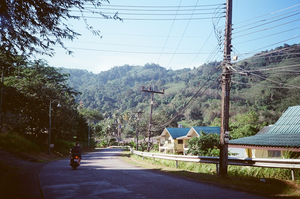 a person riding a motorcycle down a road