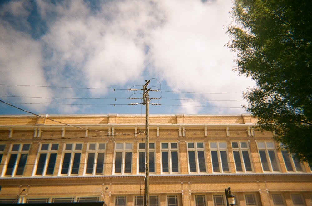 a tall building with lots of windows next to a street light