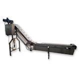 The image features a piece of industrial equipment, specifically a conveyor belt system with an angled section for transporting items. It includes a motorized control unit and support structure with metal components.