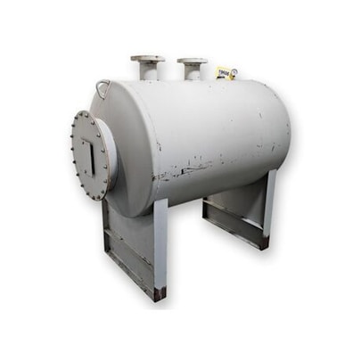 A large, industrial-grade cylindrical tank made of metal, standing on two sturdy rectangular supports. It has a riveted circular end cap and two pipe outlets or connectors on top.