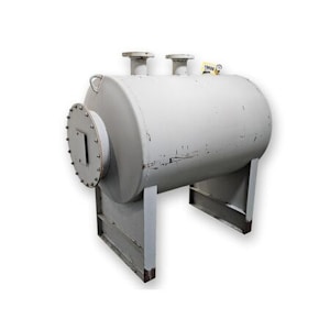 A large, industrial-grade cylindrical tank made of metal, standing on two sturdy rectangular supports. It has a riveted circular end cap and two pipe outlets or connectors on top.