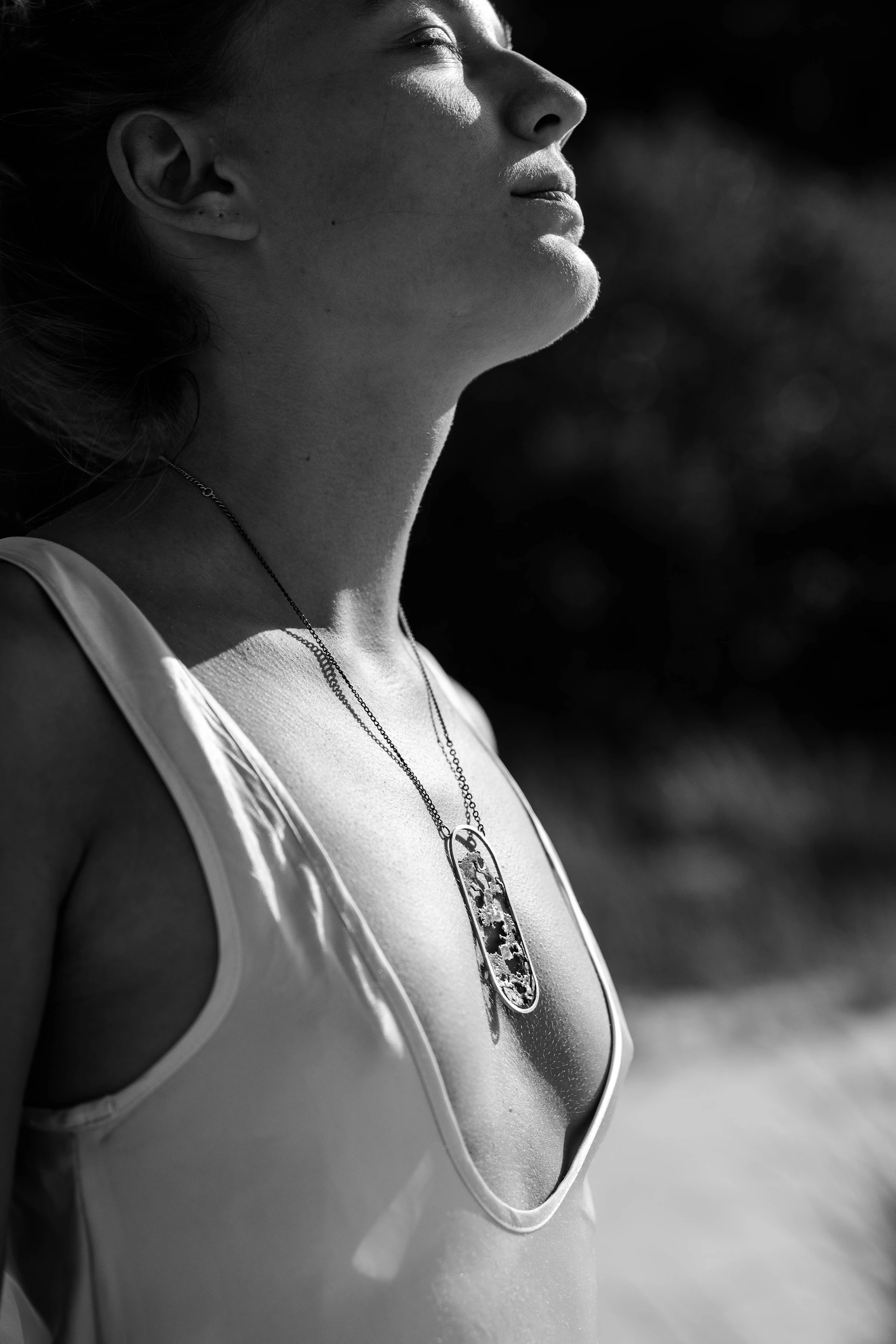 a woman in a tank top is looking up