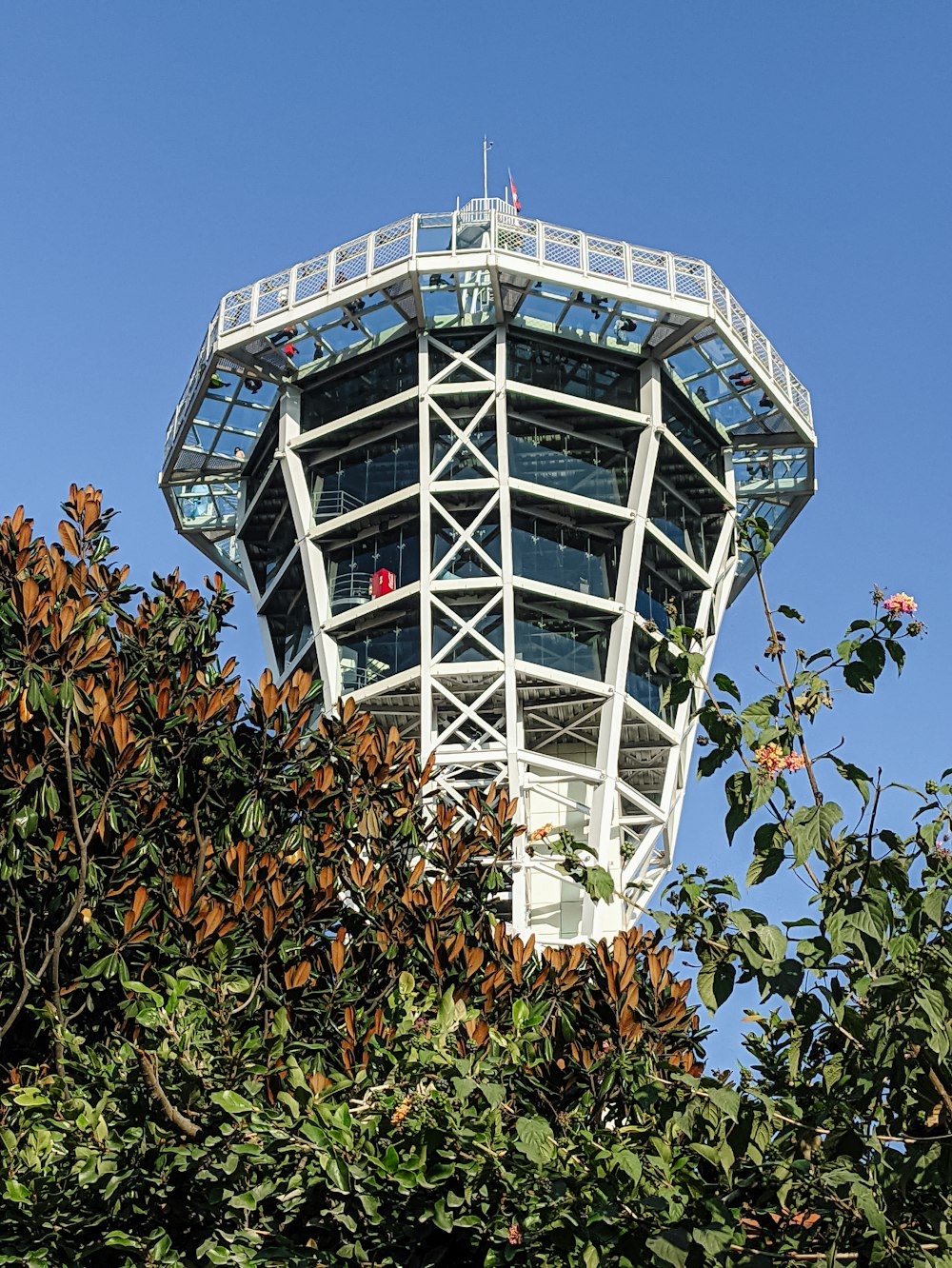 a tall tower with a metal structure on top of it