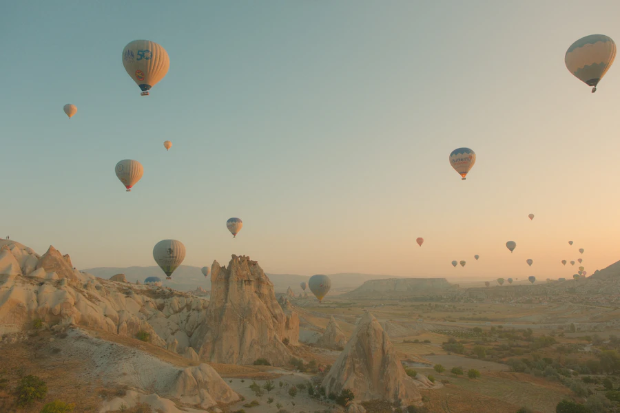 Colorful hot air balloons traveling across a bright sky