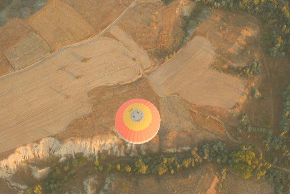 an aerial view of a hot air balloon in a field