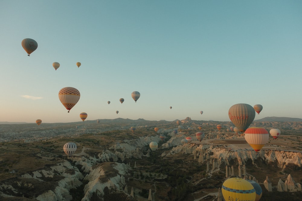 a bunch of hot air balloons flying in the sky