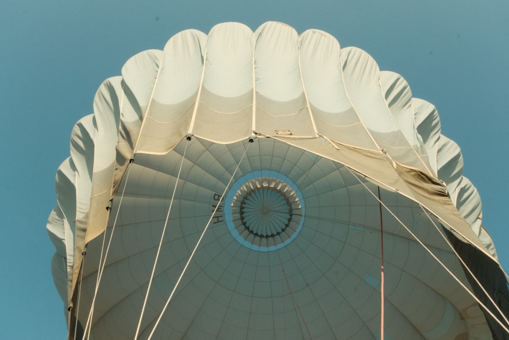 a large white umbrella with a blue sky in the background