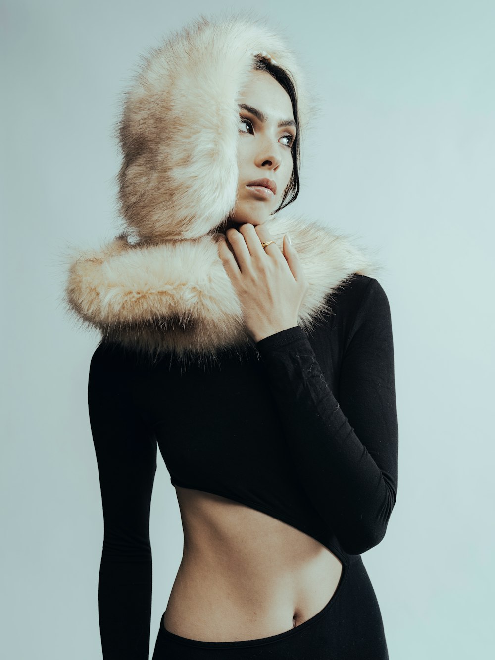 a woman in a black top with a fur hood