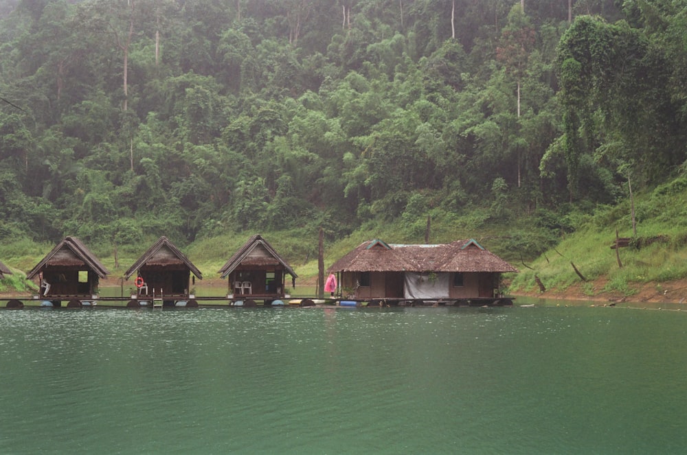 a row of huts sitting on top of a body of water