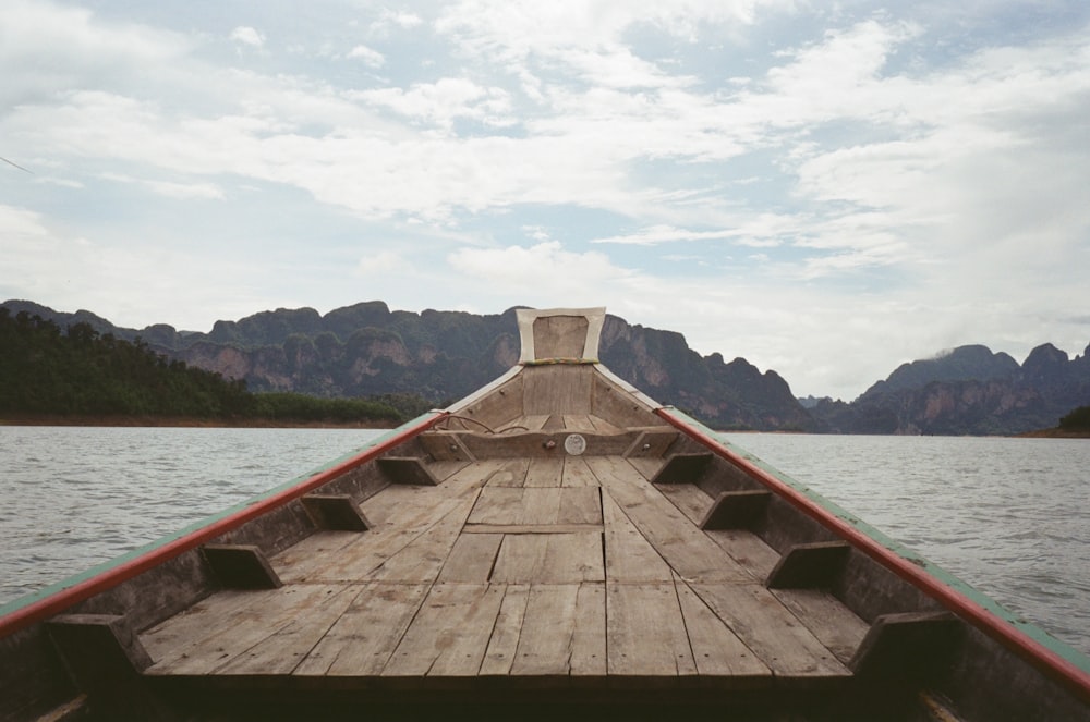 a wooden boat traveling across a large body of water