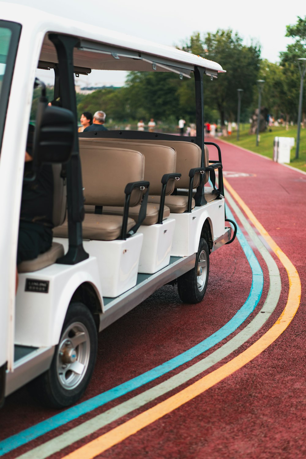 a white golf cart parked on the side of a road