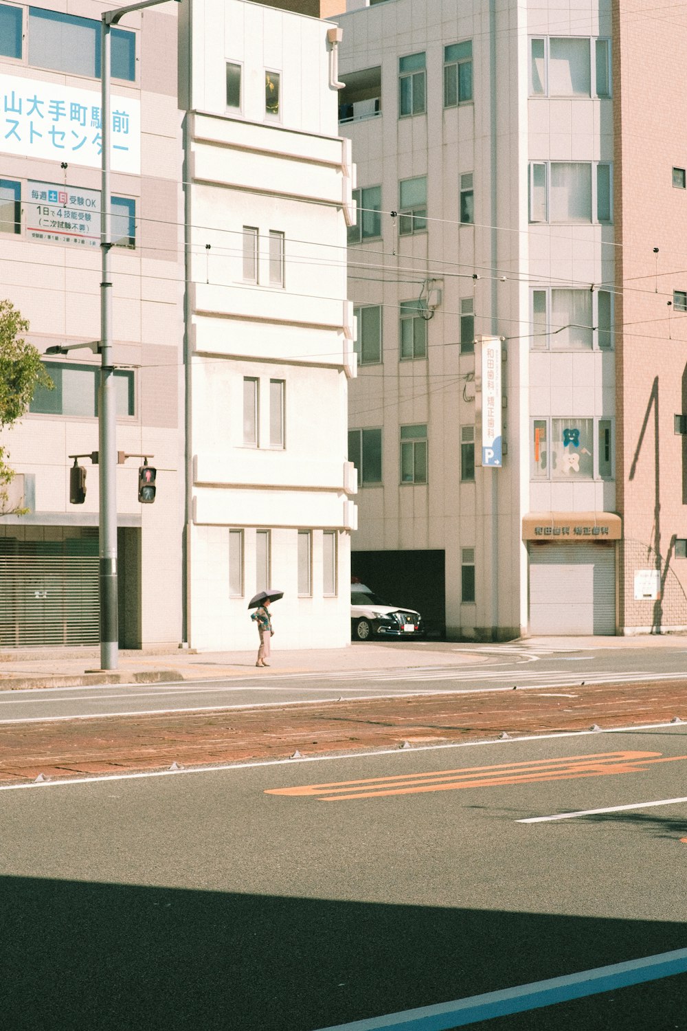 a person walking down a street with an umbrella