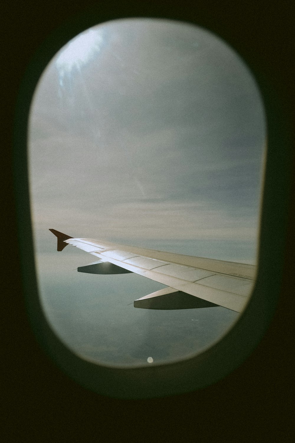 a view of the wing of an airplane through a window