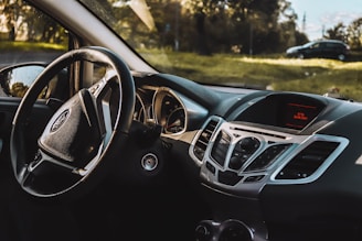 the dashboard of a car with a steering wheel