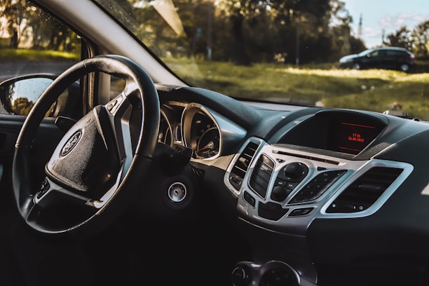 the dashboard of a car with a steering wheel