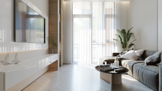 A cozy living room featuring a wall-mounted TV with a neat cable management box and a modern media console table.