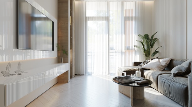 A bright living room with a sleek TV stand and a comfortable sofa, showcasing contemporary furniture.