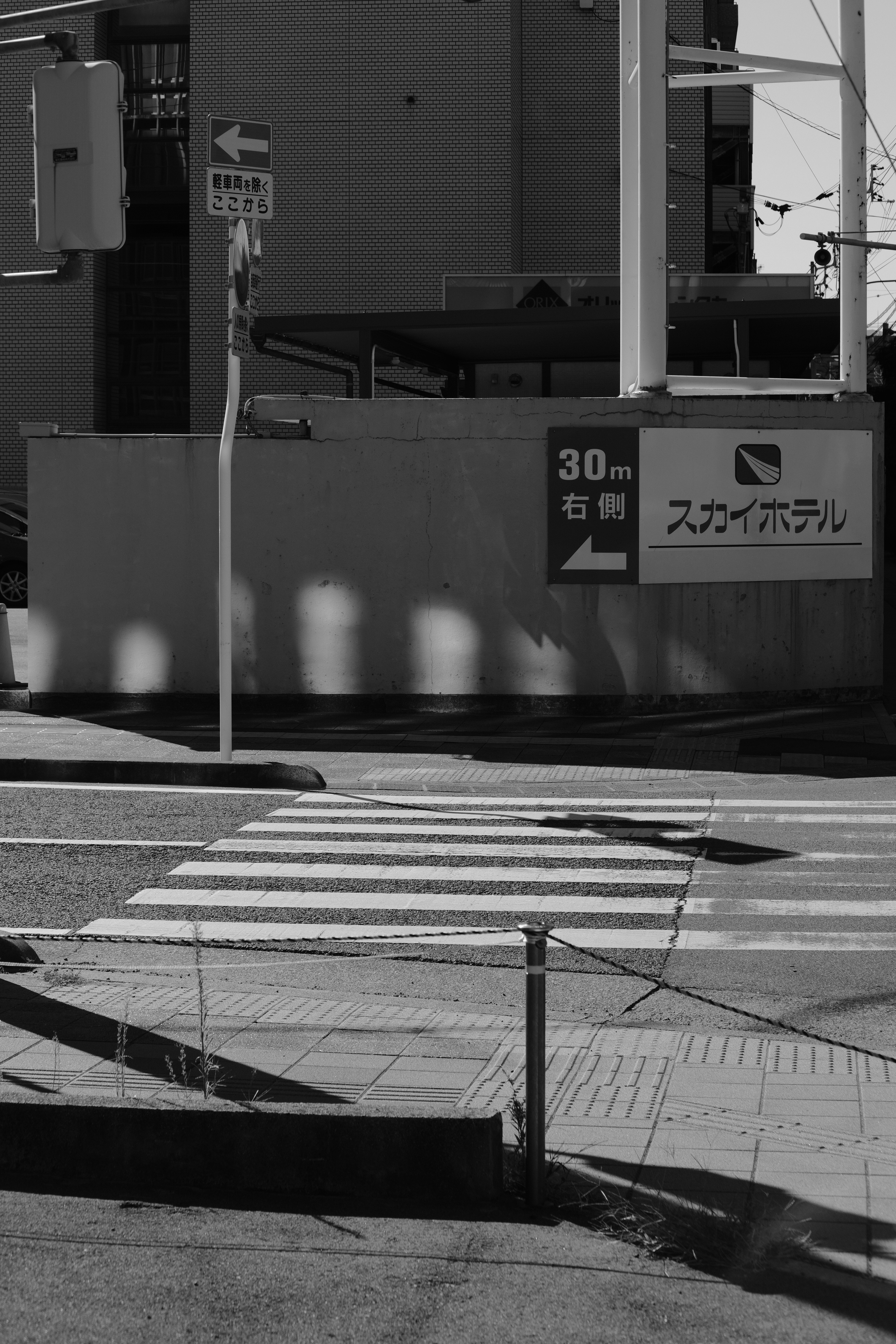 a black and white photo of a street corner