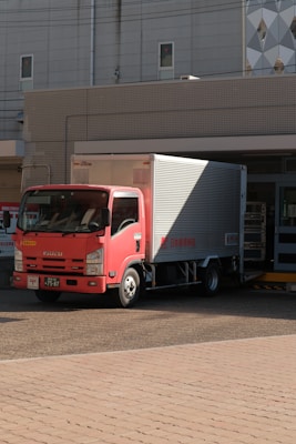 a red truck parked in front of a building