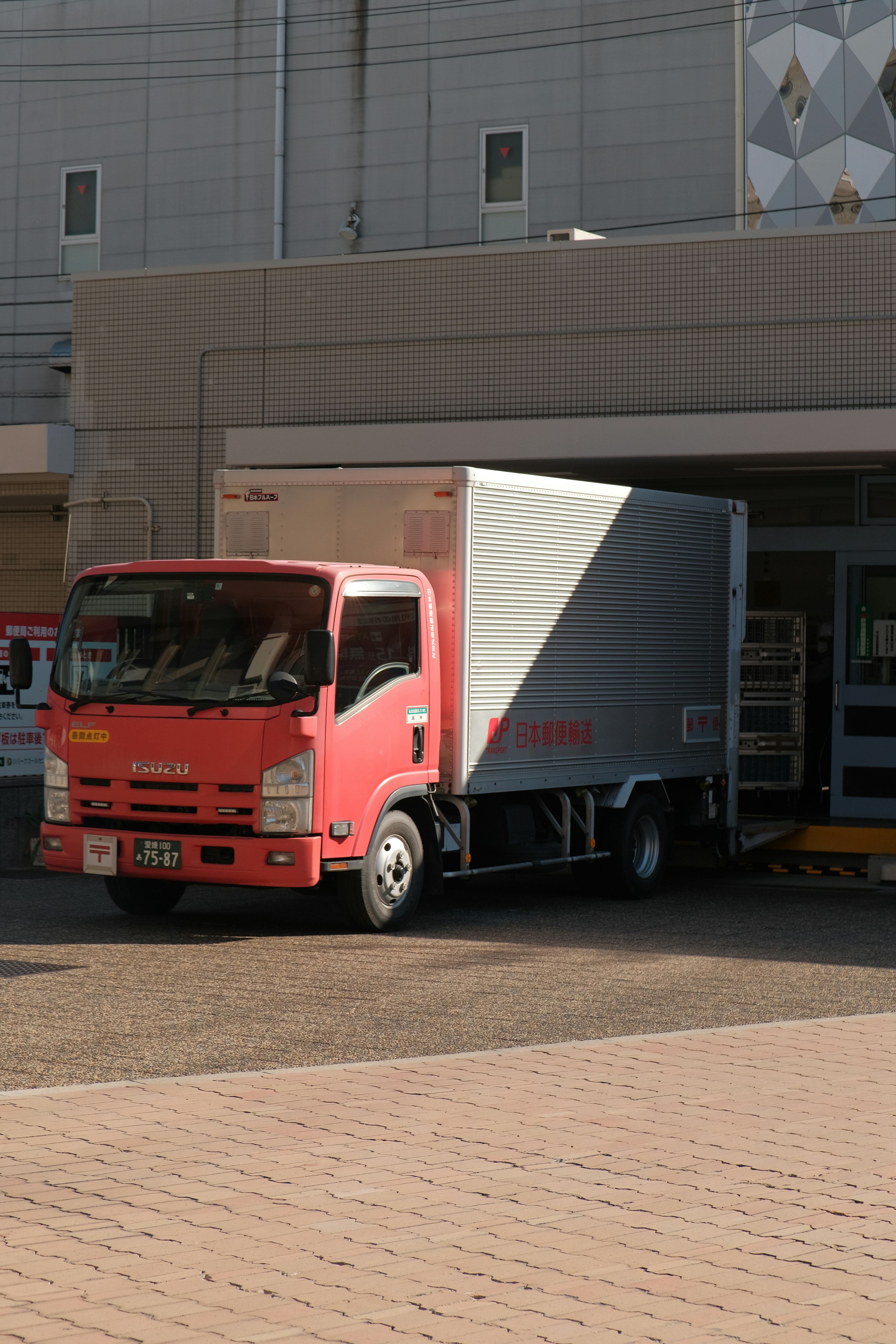 a red truck parked in front of a building