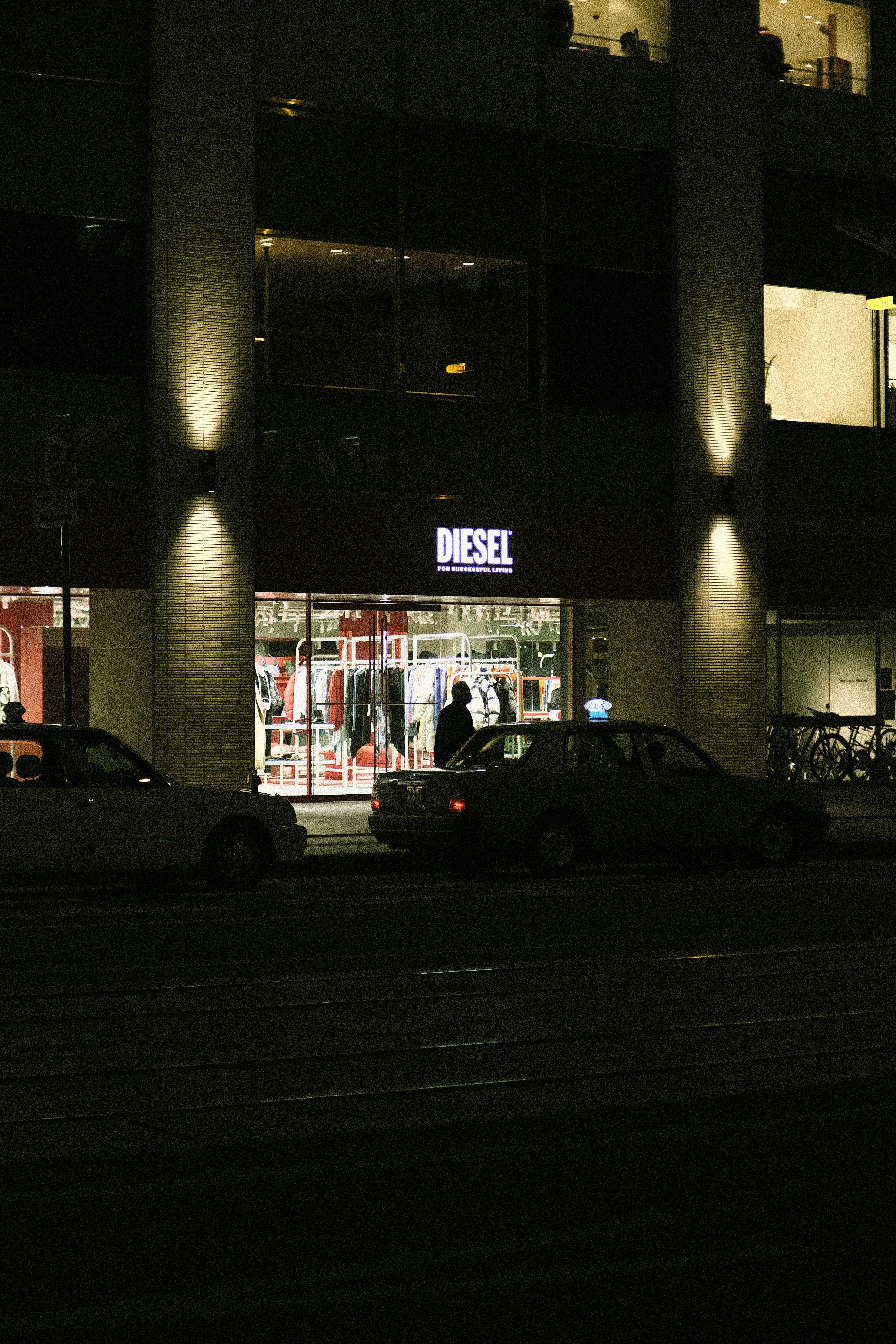 a couple of cars parked in front of a building