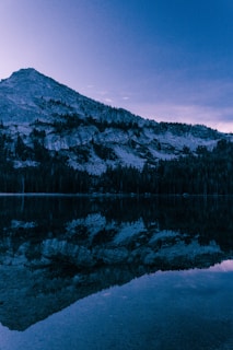 A serene mountain landscape at dawn reflecting Kanak's love for nature and balance.