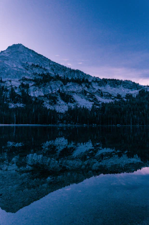 A serene mountain landscape under a deep navy sky, conveying stability and inner strength.