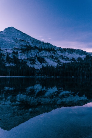 A serene mountain landscape at dawn reflecting Kanak's love for nature and balance.
