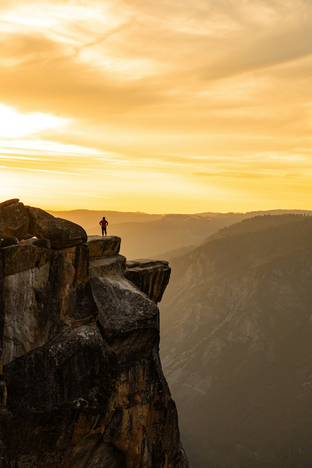 a person standing on top of a cliff